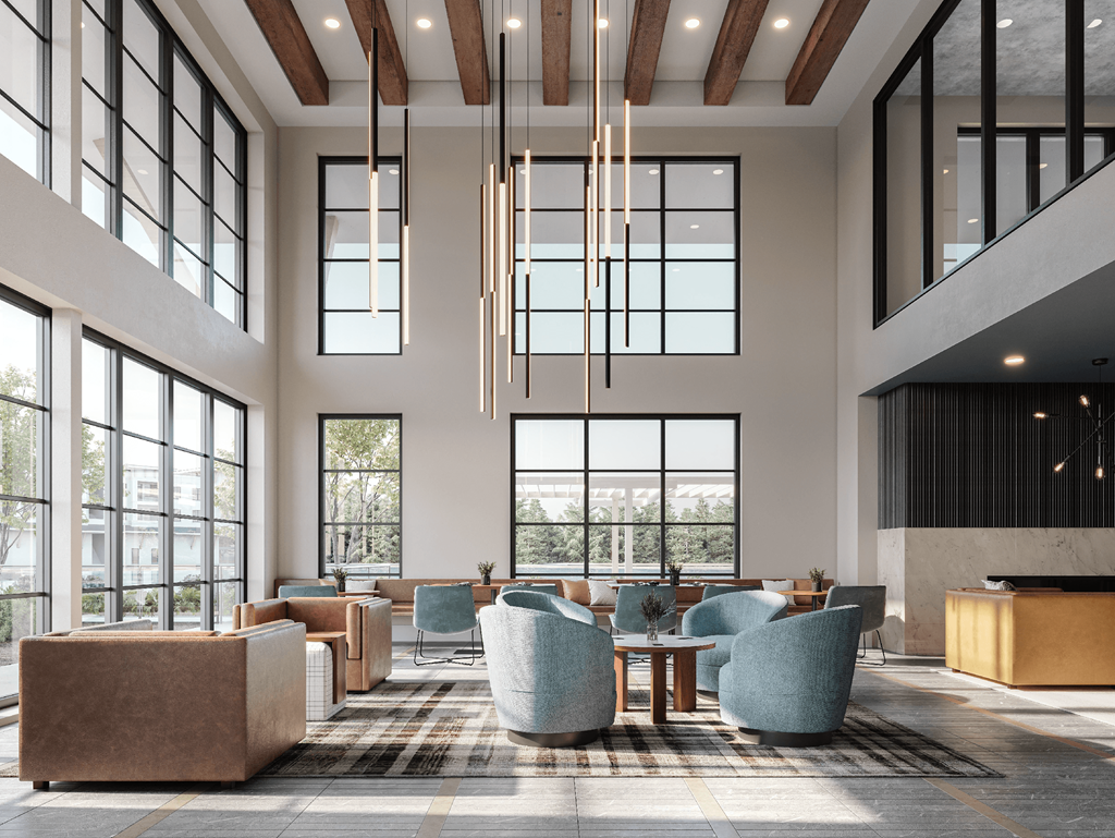 a lobby with couches and chairs and large windows