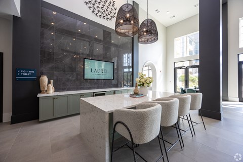 a kitchen with a marble counter top and a table with chairs