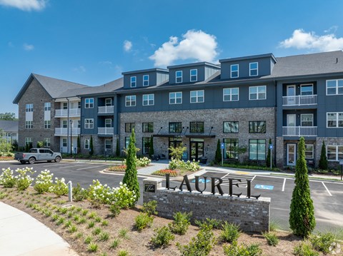 a large building with a large sign in front of a parking lot