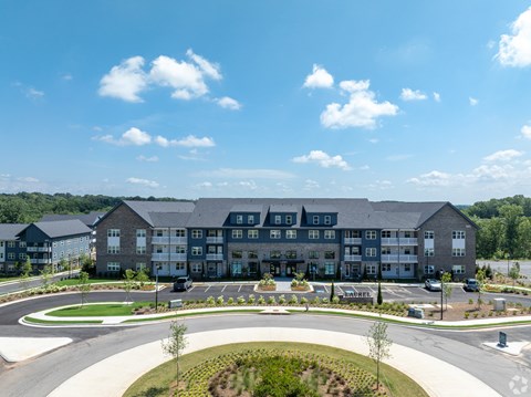 an aerial view of an apartment building overlooking a parking lot