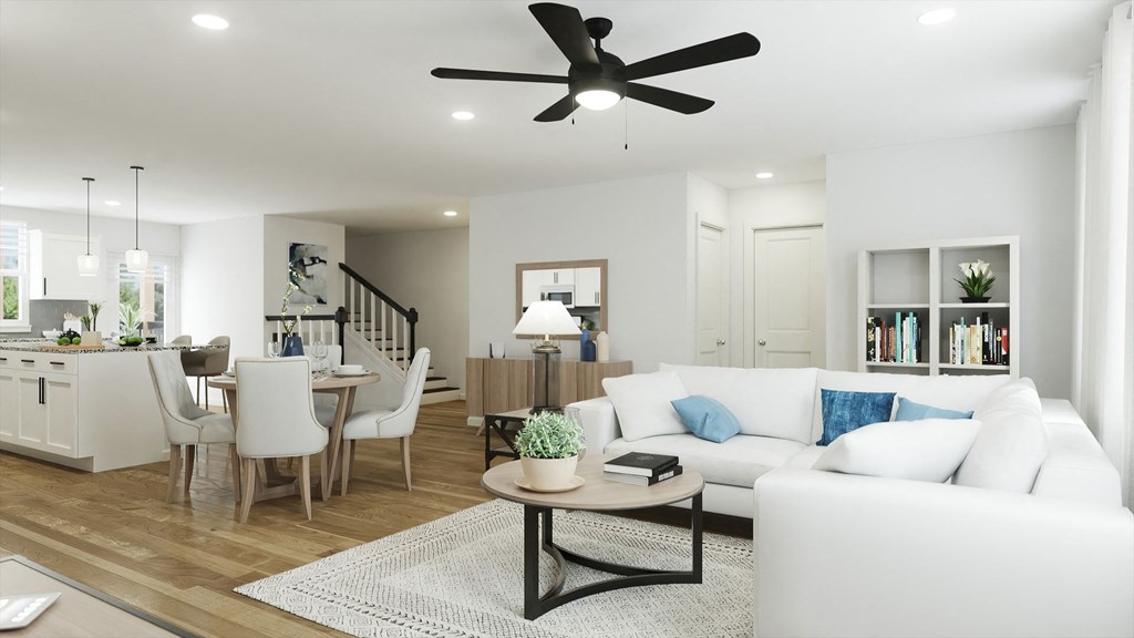 a living room with white couches and a coffee table with a plant on top of it