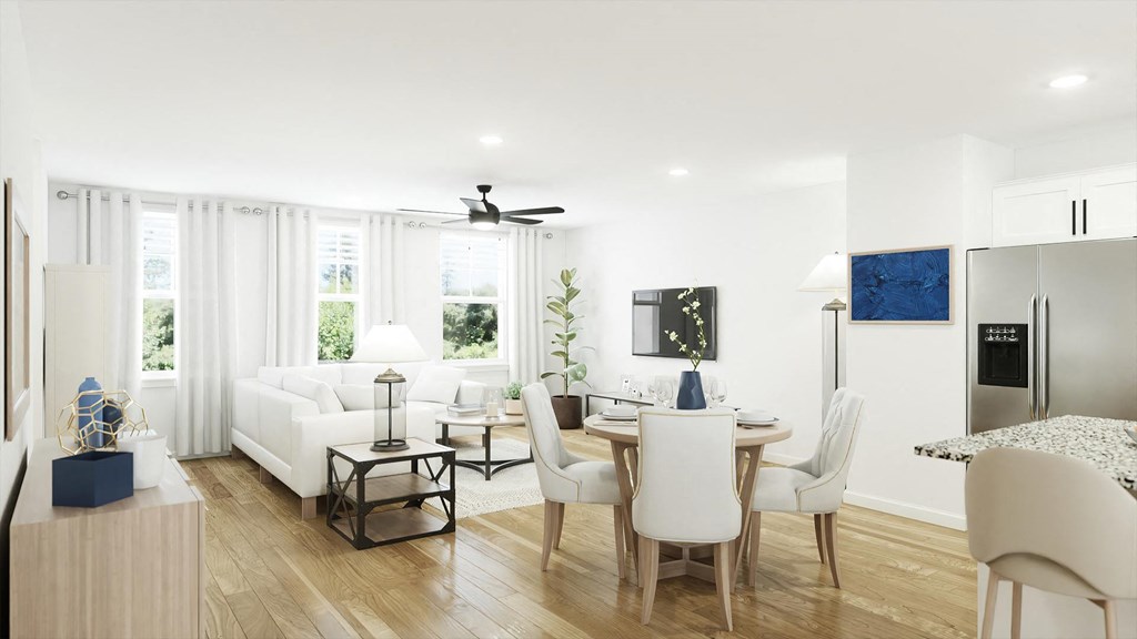 a living and dining room area with white walls and hardwood floors