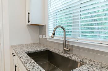 a kitchen with a sink and a window