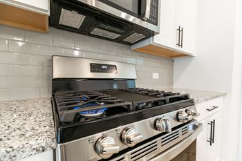 a kitchen with a stove and microwave
