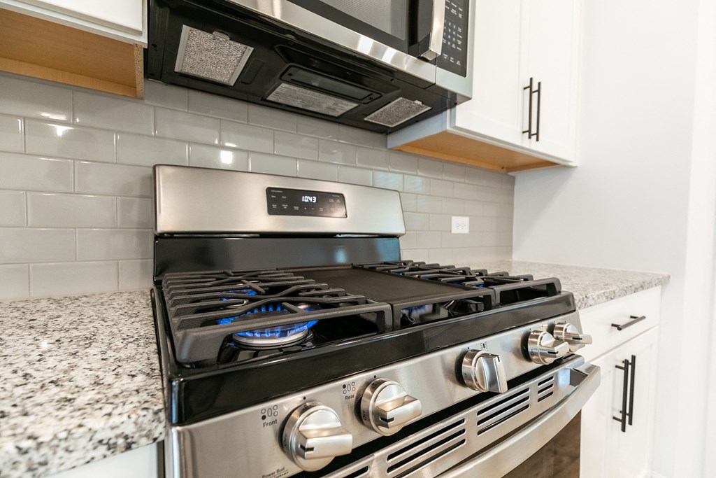 a kitchen with a stove and microwave
