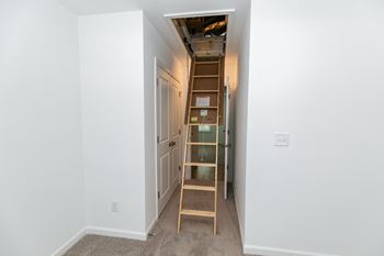 a ladder leading up to a loft in a bedroom