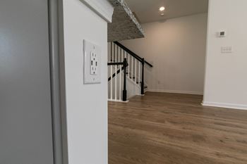 a bedroom with a medium sized bed and a staircase in a house