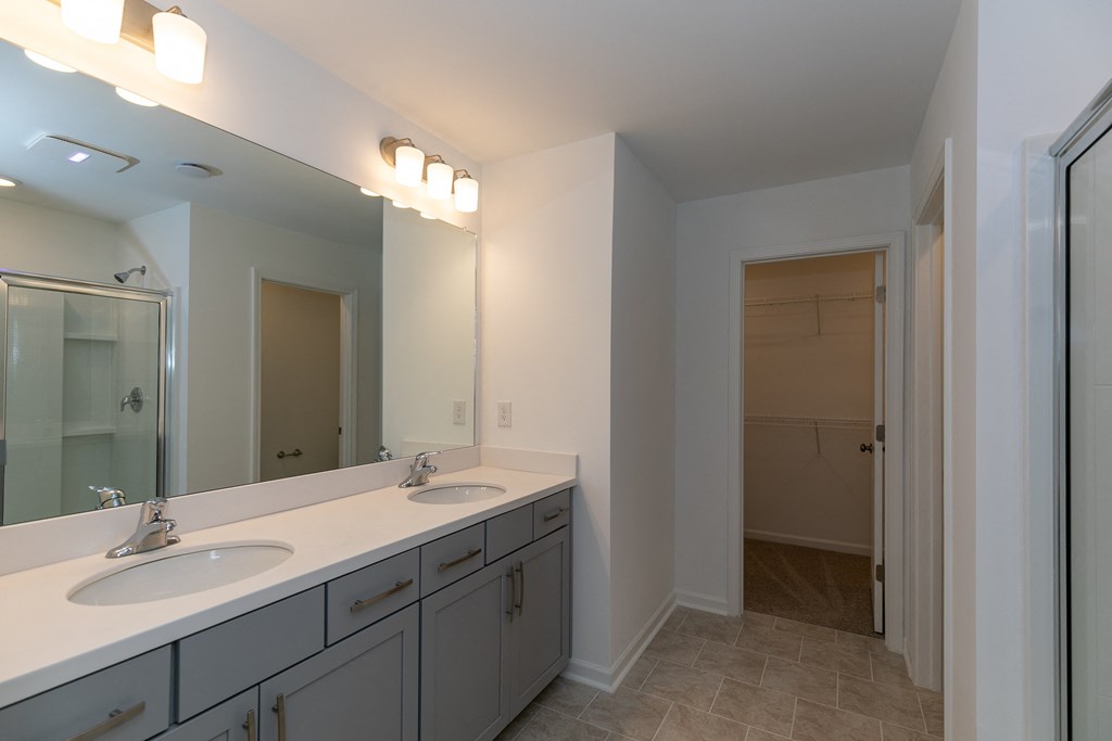 a bathroom with a large mirror and two sinks