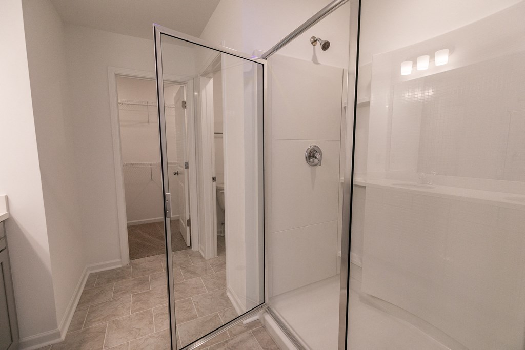 a bathroom with a walk in shower and a bathtub