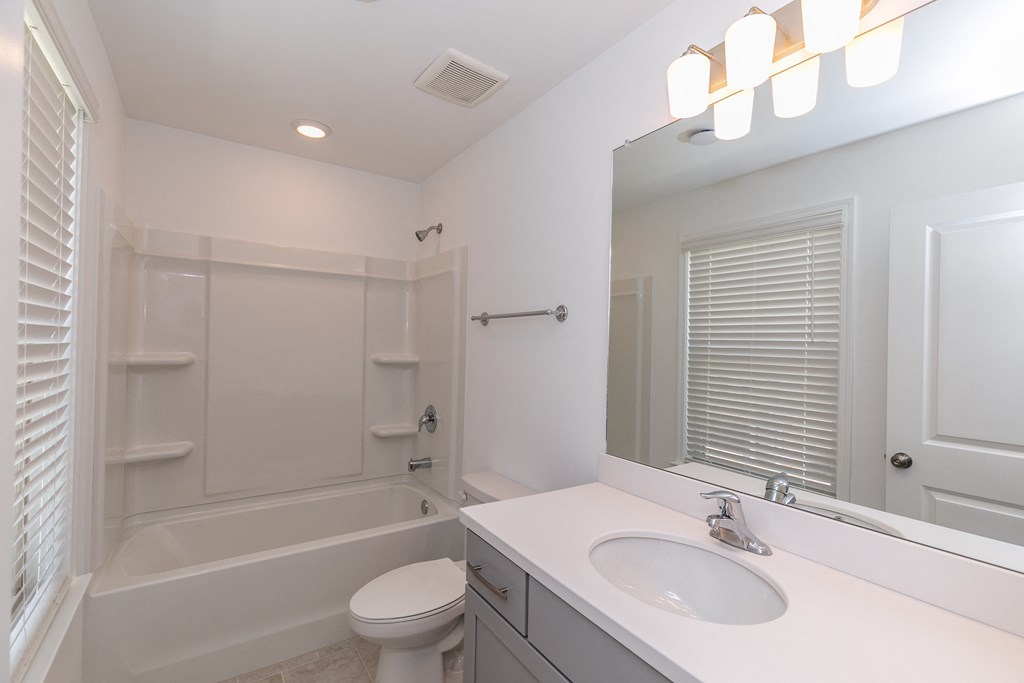 a bathroom with a bathtub and a sink