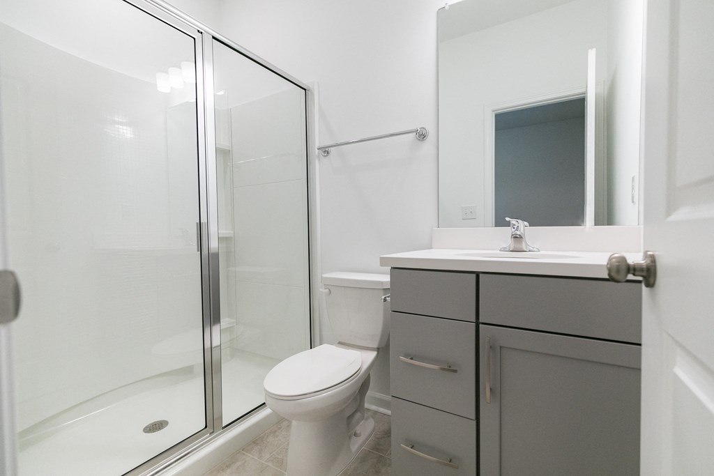 a bathroom with a toilet sink and shower