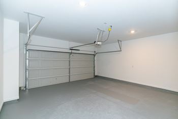 a garage with white walls and a gray floor