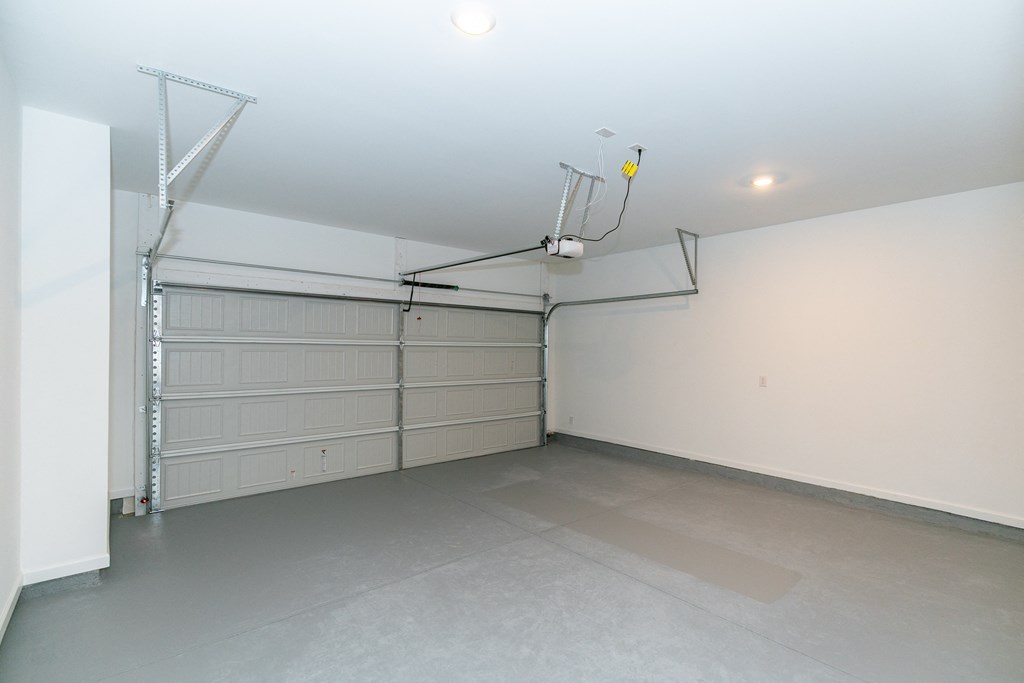 a garage with white walls and a gray floor