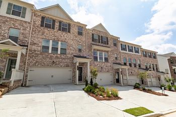a large brick apartment building with a driveway in front of it