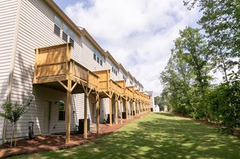 a large white building with a wooden deck