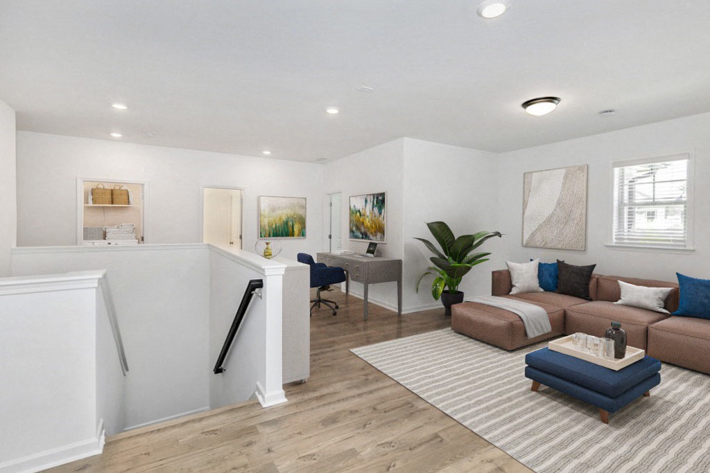 a living room with white walls and hardwood floors