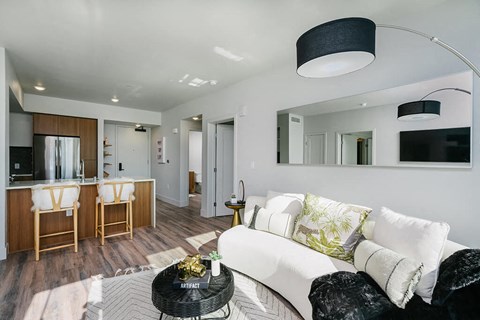A modern living room with a white couch and a black coffee table.
