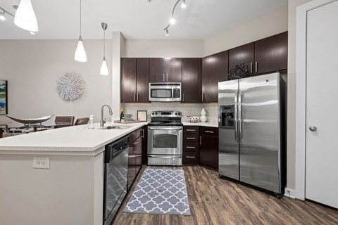 a kitchen with stainless steel appliances and a counter top