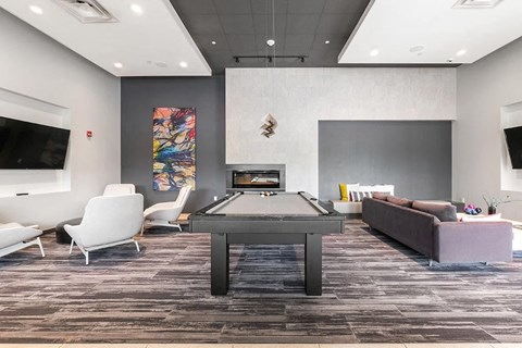 a games room with a ping pong table and a fireplace