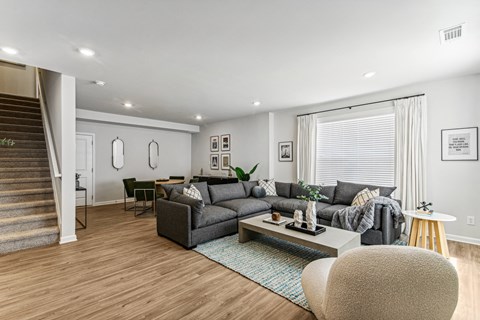 A living room with a grey couch and a coffee table.