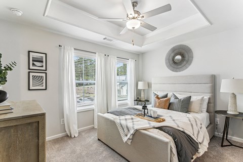 a bedroom with a large bed and a ceiling fan