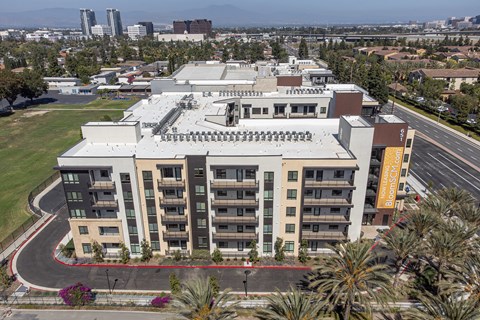 an aerial view of a building with a parking lot in front of it