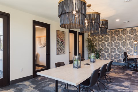 a conference room with a long table and chairs and a large chandelier
