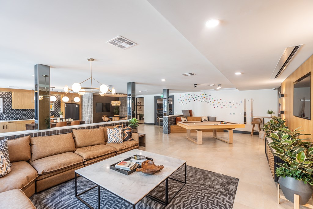 a living room filled with furniture and a large window