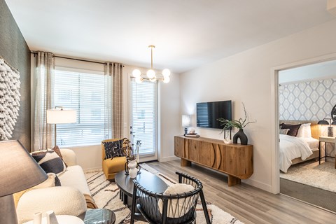 a living room with a couch coffee table and tv