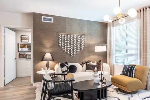 a living room with a white couch and a yellow chair
