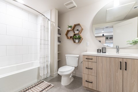 a bathroom with a toilet sink and bathtub in a 555 waverly unit