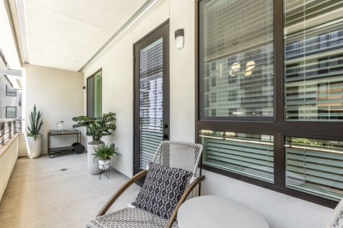 a balcony with a chair and a table