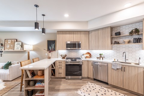 a kitchen with wooden cabinets and a white countertop