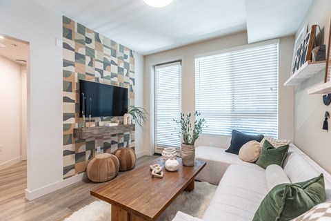 a living room with a white couch and a wooden coffee table in front of a fireplace