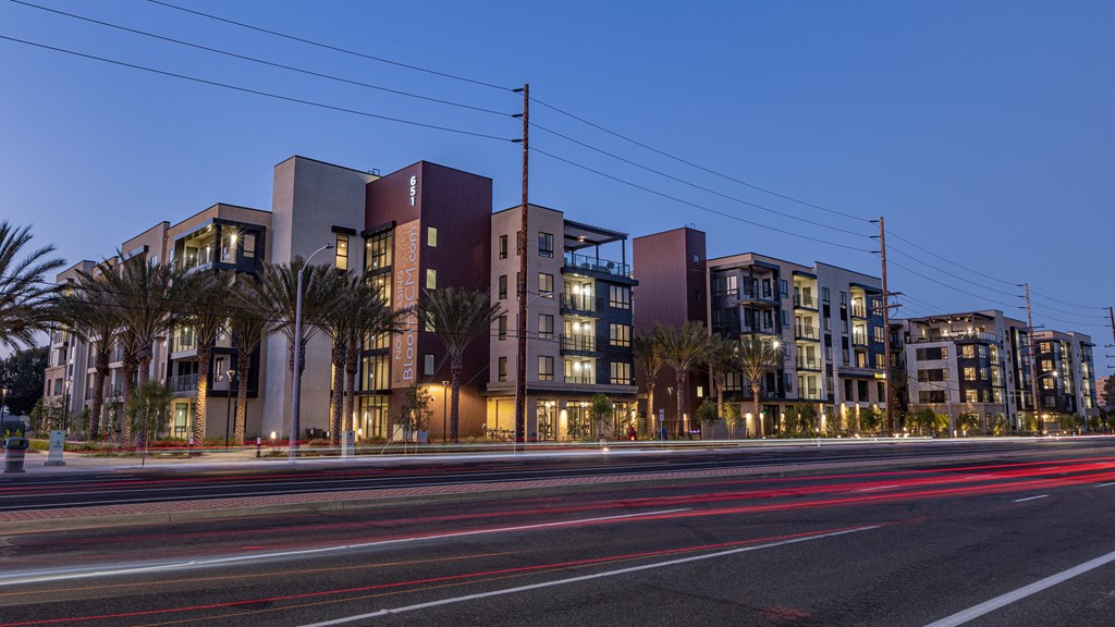 a city at night with cars on the road