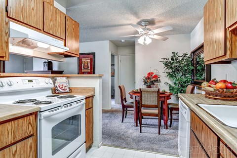 a kitchen with a stove and a dining table