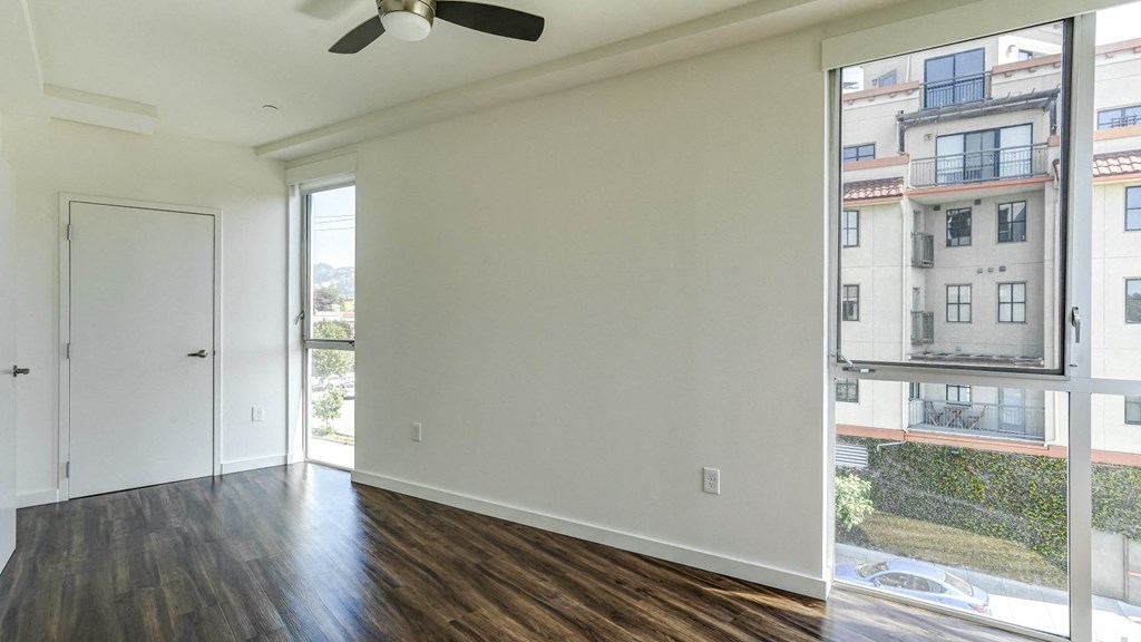 living room with a window and a ceiling fan