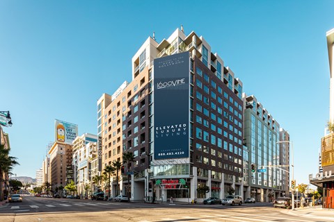 A tall building with a sign that says "Elevated Living" on the side of it.