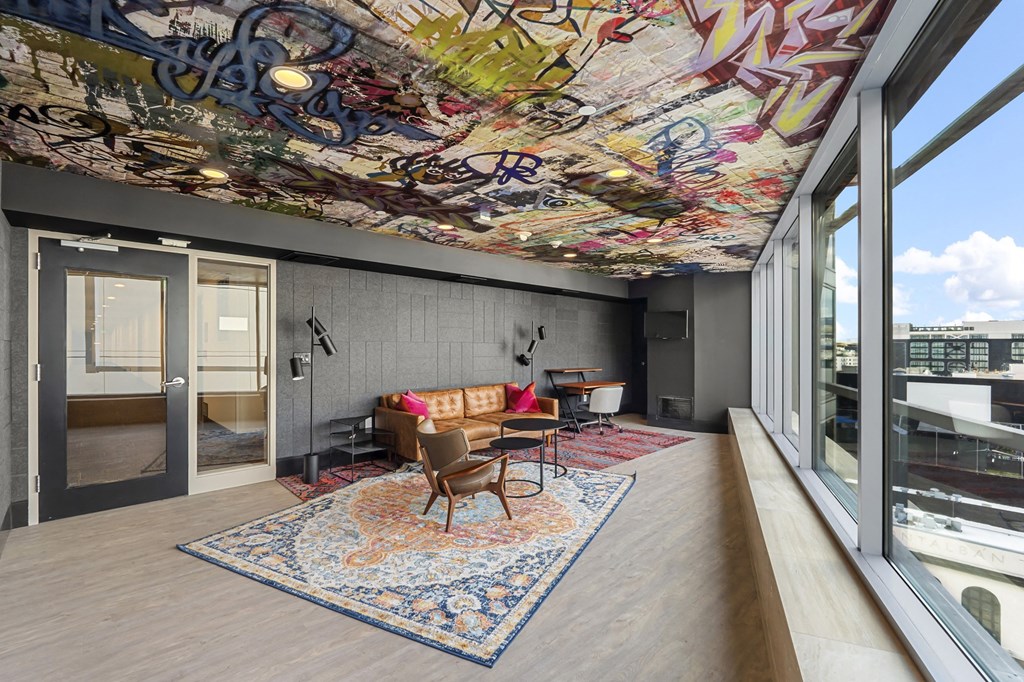 a living room with a couch and a table on a rug