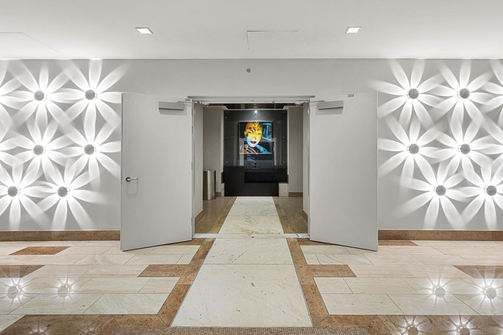 the lobby of a building with white walls and white doors