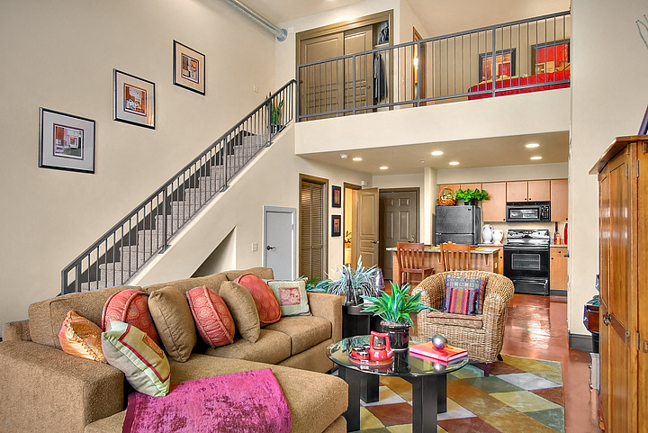 a living room with a couch and a staircase
