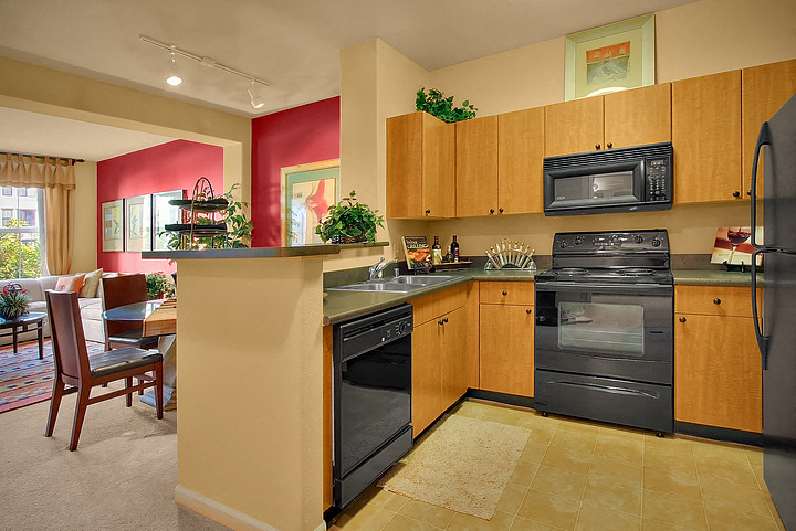a kitchen with a stove refrigerator and a sink