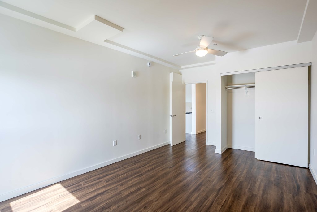 A room with wooden floors and white walls.