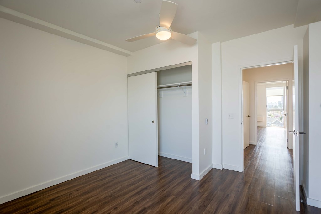 A room with a white door and a window with blinds.