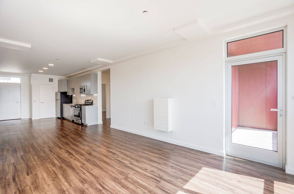 A kitchen area with a refrigerator, microwave, and oven.