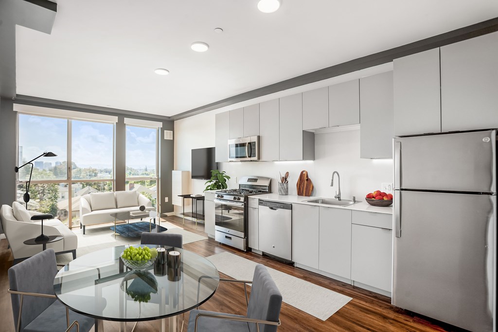 A modern kitchen with white cabinets and stainless steel appliances.
