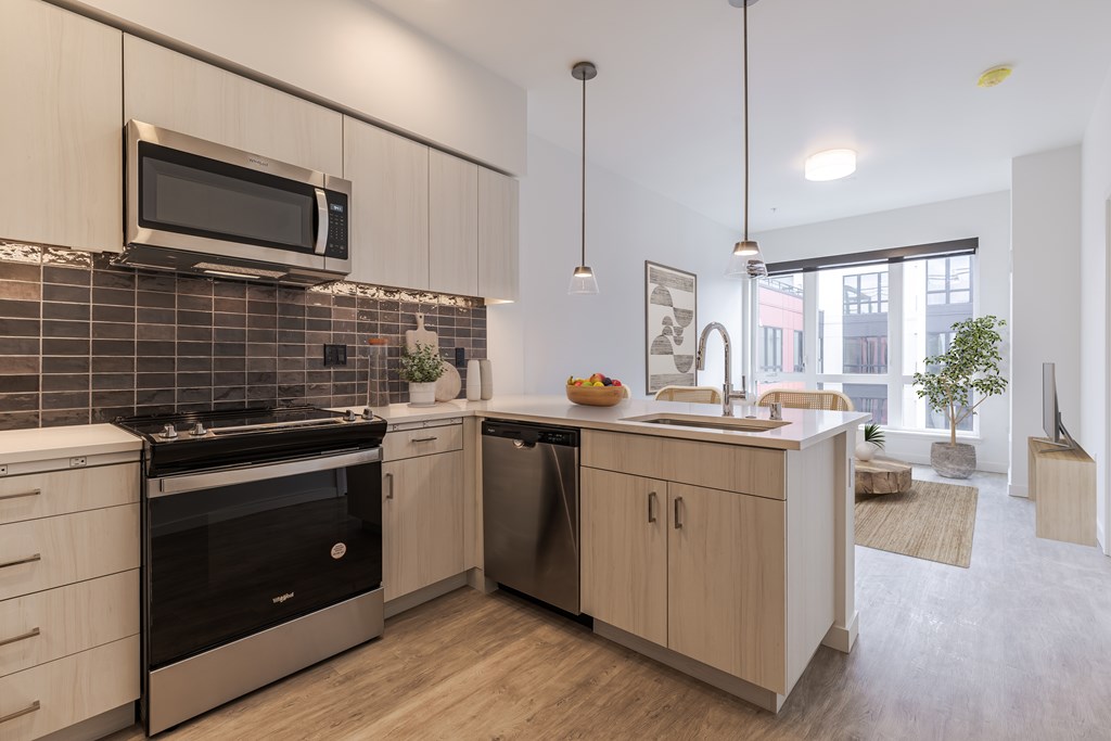 A modern kitchen with a black oven and a microwave above the stove.
