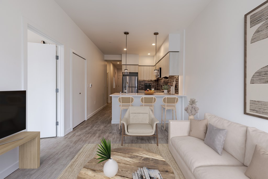 A modern living room with a white couch, a wooden coffee table, and a flat-screen TV.