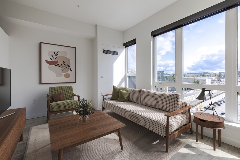 A living room with a couch, chair, and coffee table.