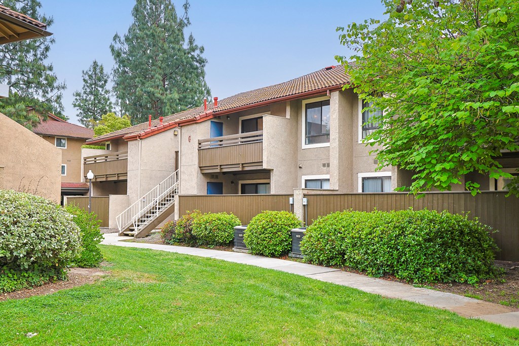Apartment complex with a green lawn in front.